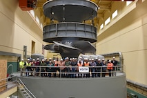 A group of USACE and Voith employees celebrate in front of the newly assembled turbine unit 1 at Ice Harbor Lock and Dam, near Burbank, Wash.
