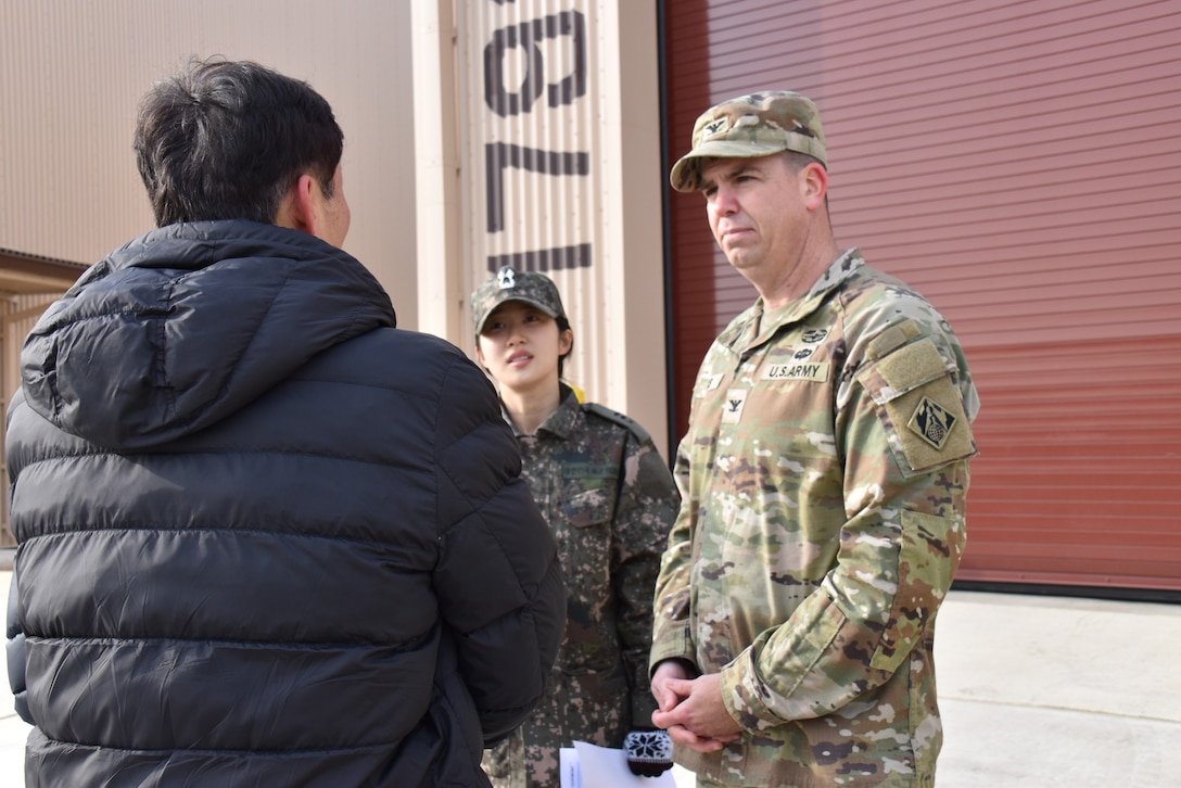 Col. Jeremiah Willis, commander, U.S. Army Corps of Engineers – Far East District, engages with Mr. Kim, Kyong-Chan, deputy chief of USFK Programs, Republic of Korea Ministry of National Defense – Defense Installation Agency, after a ribbon cutting for a new Airfield Damage Repair warehouse, Osan Air Base, on Dec. 3, 2025.