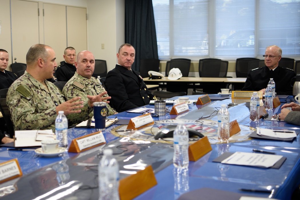 Capt. Jon Hopkins, Commander, Fleet Activities Yokosuka (CFAY), left, addresses Chief of Naval Operations Adm. Daryl Caudle during a briefing at the installation Ship's Repair Facility (SRF).