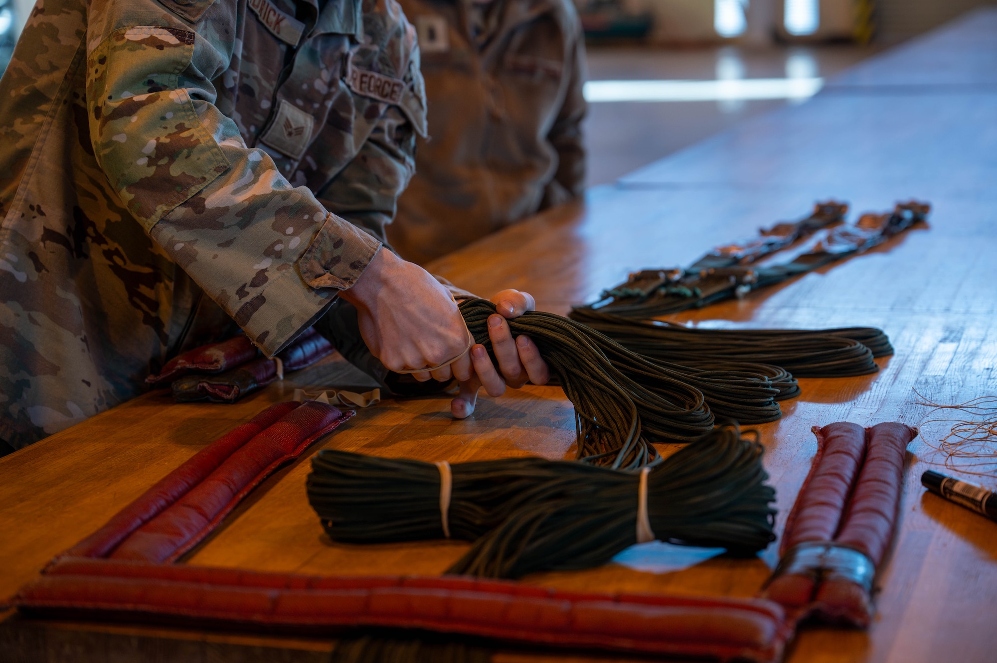 U.S. Air Force Senior Airman Gabriel Bundrick, 374th Logistics Readiness Squadron combat mobility flight combat mobility technician, holds a parachute rigging demonstration.
