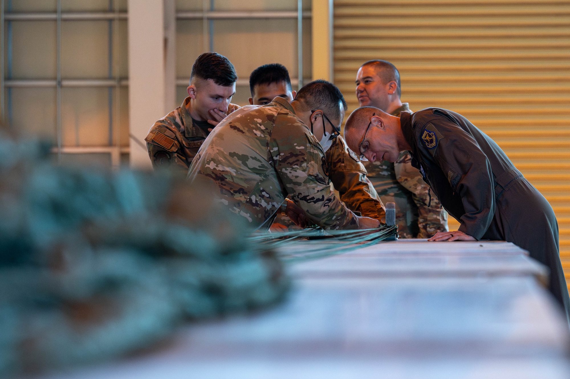 Members assigned to the combat mobility flight of the 374th Logistics Readiness Squadron showcase parachute rigging operations.