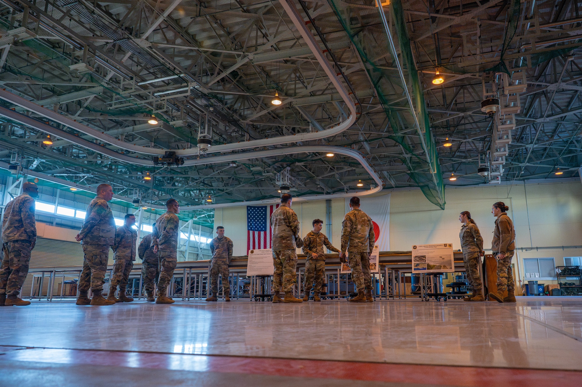 U.S. Air Force Airmen assigned to the 374th Logistics Readiness Squadron combat mobility flight brief 374th Airlift Wing leadership.