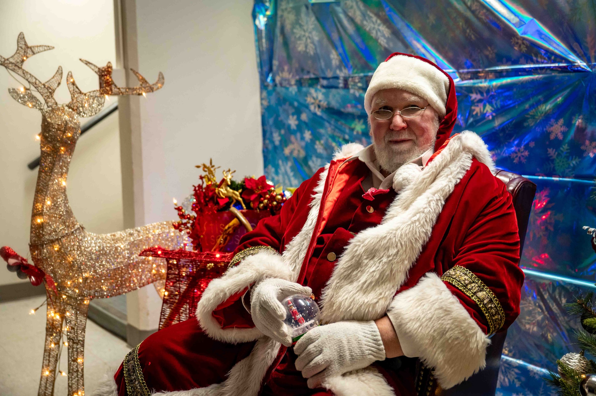 Santa Claus entertains attendees during the annual tree lighting ceremony at Joint Base Elmendorf-Richardson, Alaska, Dec. 2, 2025. The 773d Force Support Squadron hosts the ceremony annually to promote community readiness and cohesion during the festive season. (U.S. Air Force photo by Senior Airman Hunter Hites)