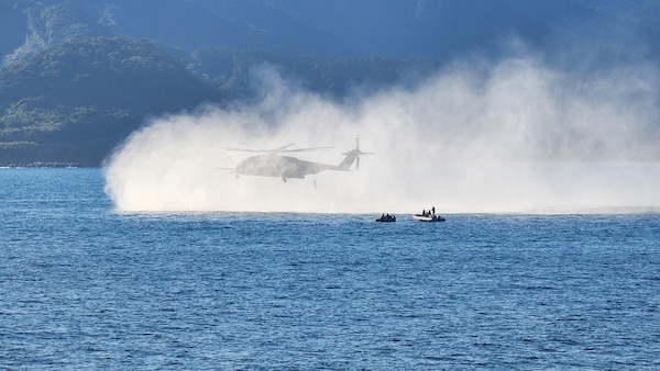 Explosive Ordnance Disposal Mobile Unit (EODMU) 5 Expeditionary Mine Countermeasures (ExMCM) Company 9-3 and Japan Maritime Self-Defense Force (JMSDF) EOD teams jump from an MH-53E Sea Dragon from Helicopter Mine countermeasures squadron 15 (HM-15) during a helicopter casting exercise as part of Mine Warfare Exercise (MINEX) 3JA, Nov. 22, 2025.
