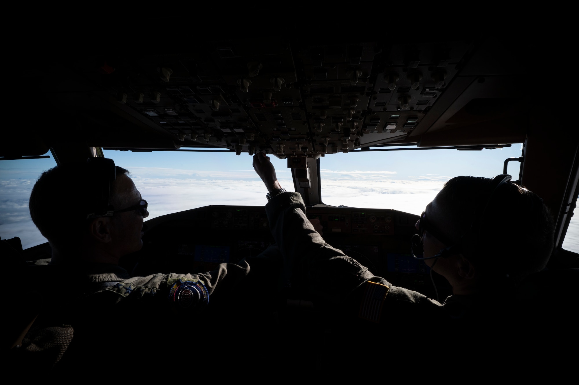 From left, U.S. Air Force Gen. Johnny Lamontagne, Air Mobility Command commander, and Capt. Dustin Raab, 9th Aerial Refueling Squadron KC-46A Pegasus instructor pilot, fly the 100th U.S. Air Force KC-46A during its initial delivery to Travis Air Force Base, California, Dec. 2, 2025. Lt. Gen. John Healy, chief of the Air Force Reserve and the commander of Air Force Reserve Command, flew the 99th KC-46A in formation alongside Lamontagne. (U.S. Air Force photo by Staff Sgt. Dalton Williams)