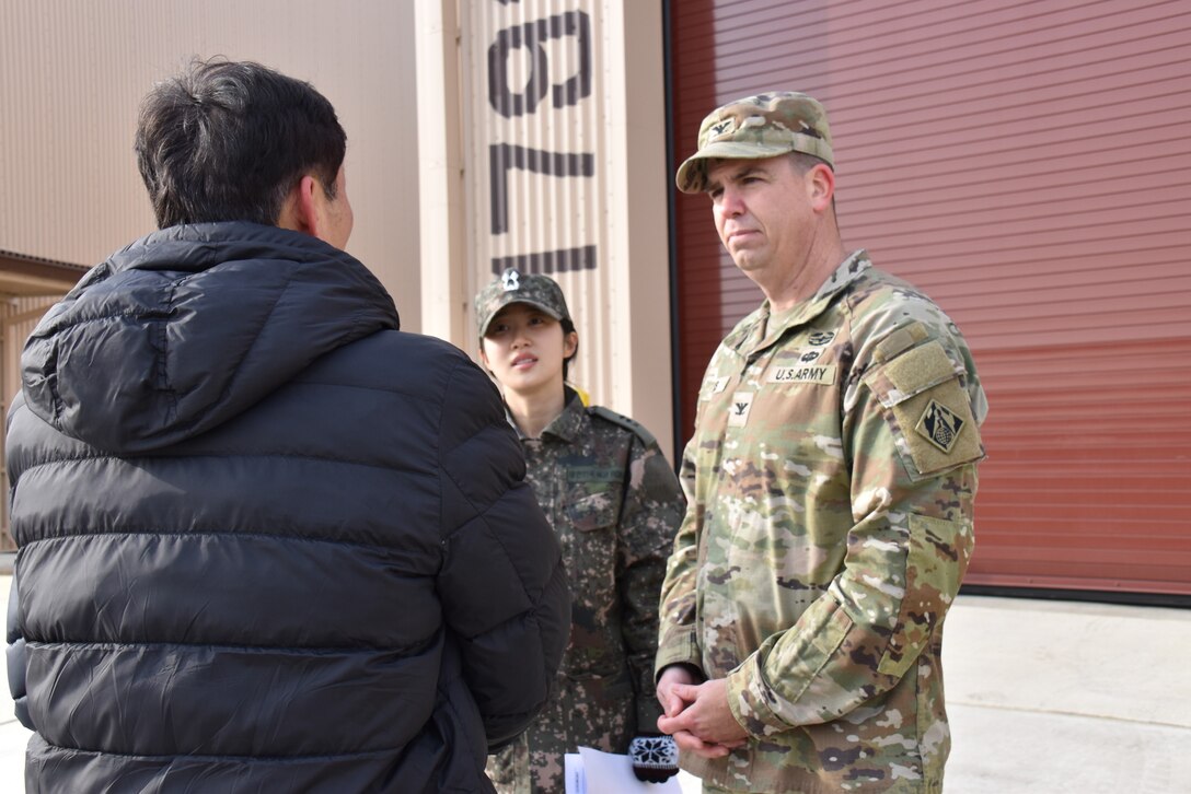 Col. Jeremiah Willis, commander, U.S. Army Corps of Engineers – Far East District, engages with Mr. Kim, Kyong-Chan, deputy chief of USFK Programs, Republic of Korea Ministry of National Defense – Defense Installation Agency, after a ribbon cutting for a new Airfield Damage Repair warehouse, Osan Air Base, on Dec. 3, 2025.