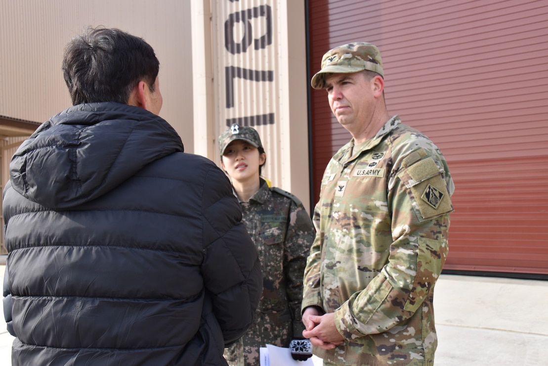 Col. Jeremiah Willis, commander, U.S. Army Corps of Engineers – Far East District, engages with Mr. Kim, Kyong-Chan, deputy chief of USFK Programs, Republic of Korea Ministry of National Defense – Defense Installation Agency, after a ribbon cutting for a new Airfield Damage Repair warehouse, Osan Air Base, on Dec. 3, 2025.