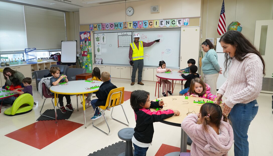 U.S. Army Corps of Engineers Japan District (USACE JED) engineering division civil engineer, Joseph Dashiell, center, explains the science behind building electrical circuits to students from Naval Air Facility Atsugi’s Shirley Lanham Elementary School during their annual Science Technology Engineering Art and Mathematics (STEAM) Day event, December 3rd, 2025. Dashiell, a civil engineer with the District’s engineering division, explained how electrical systems support USACE’s work in Japan and encouraged the children to troubleshoot, communicate, and think critically, which are key skills engineers rely on every day. Photo by Patrick Ciccarone.