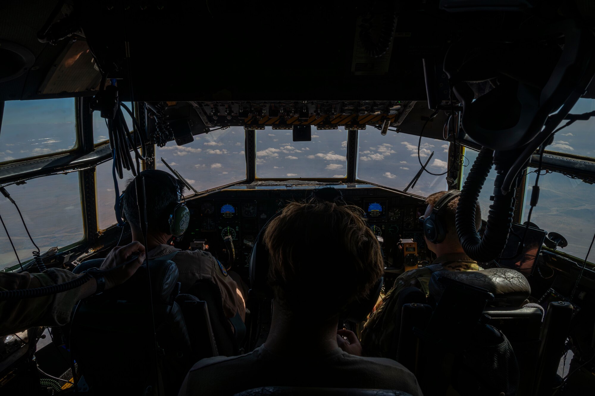Airmen of the 75th Expeditionary Airlift Squadron fly a C-130H Hercules cargo aircraft