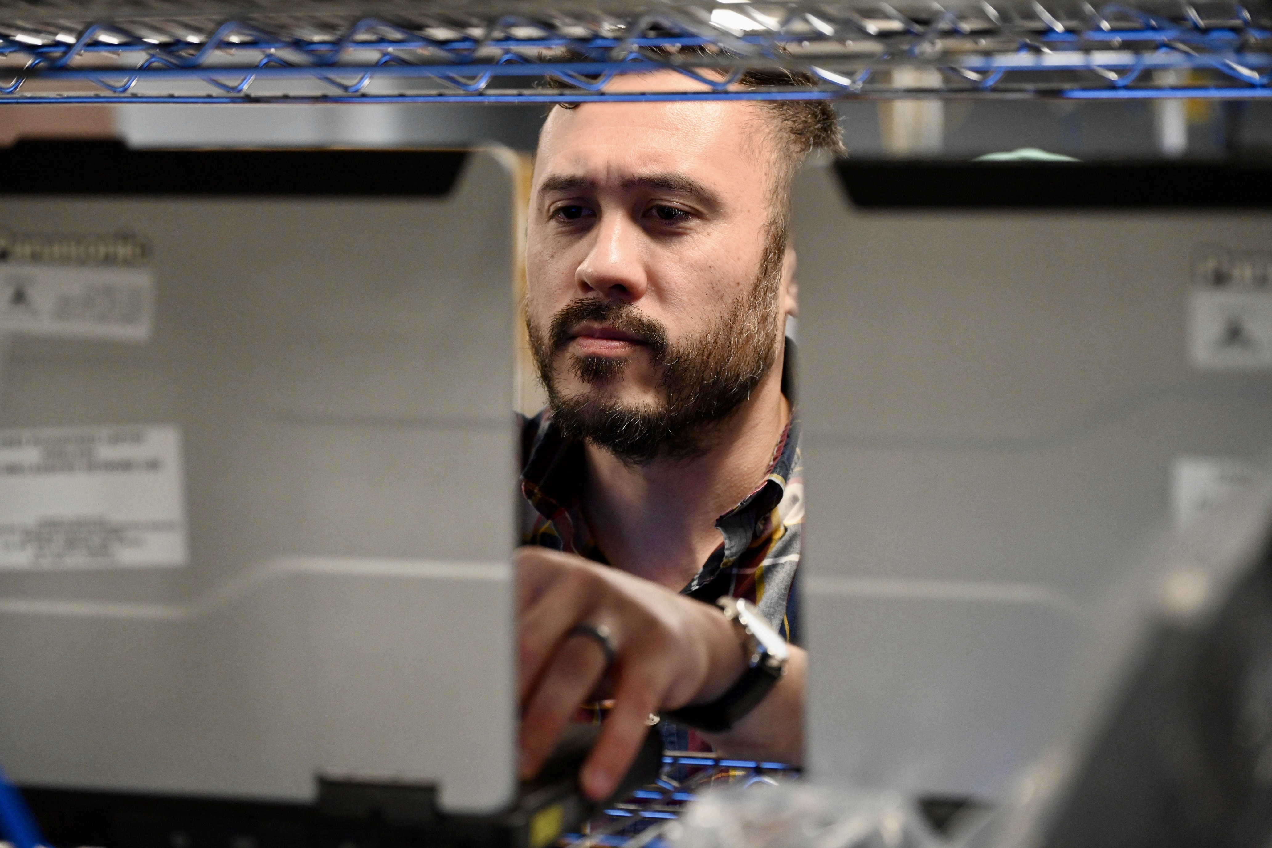 Information Systems Technician troubleshooting network hardware in a lab environment