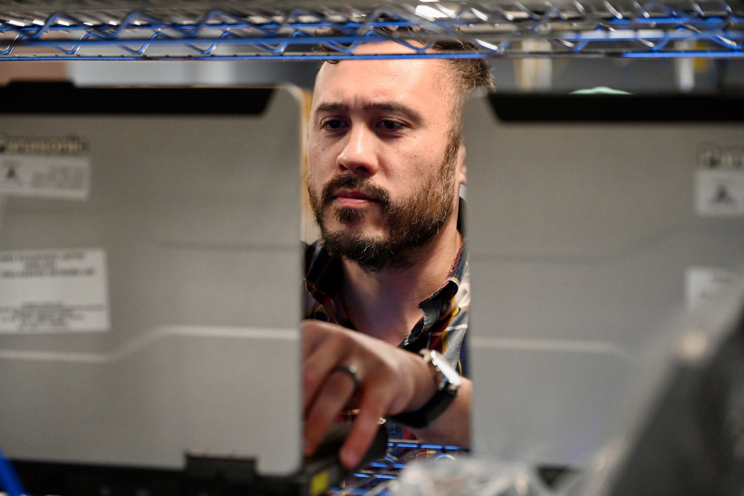 Information Systems Technician troubleshooting network hardware in a lab environment