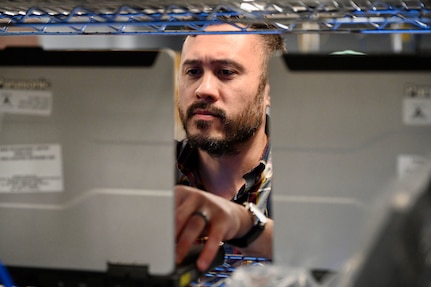 Information Systems Technician troubleshooting network hardware in a lab environment