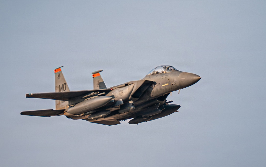A U.S. Air Force F-15E Strike Eagle aircraft flies in the U.S. Central Command area of responsibility, Nov. 13, 2025. The F-15 was returning from the Marauder Shield 26.1 exercise, a key element of which was the sharpening of combined fighter capabilities between the U.S. and Kuwait Air Forces. This included joint training exercises and hot-pit refueling operations. Hot-pits, a form of grounded aircraft refueling while engines are hot, delivered speed to airpower by minimizing turnaround time, enabling U.S. and allied forces to maintain constant vigilance and project power where needed. (U.S. Air Force photo by Airman 1st Class Jonah Bliss)