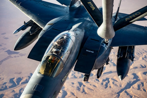 A U.S. Air Force F-15E Strike Eagle aircraft assigned to the 391st Expeditionary Fighter Squadron, approaches the boom of a KC-135T Stratotanker aircraft during an aerial refueling mission in the U.S. Central Command area of responsibility, Oct. 11, 2025. The Strike Eagle plays a key role in sustaining regional stability by supporting deterrence, defensive operations, and coalition airpower integration. (U.S. Air Force photo by Staff Sgt. Kristen Heller)