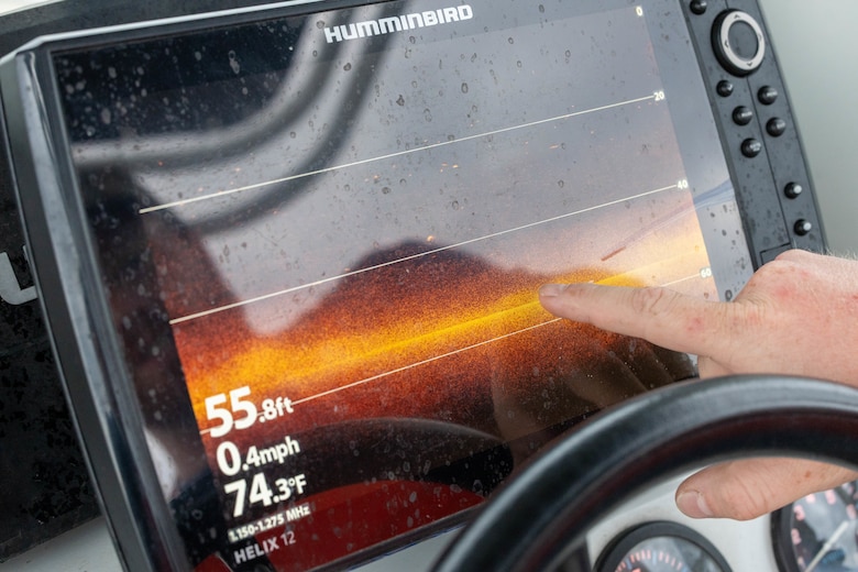 A hand points to a black screen with orange towards the middle of the screen.