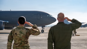 Airmen salute the arrival of an aircraft.