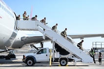 Joint Base Charleston Airmen deboard the plane upon returning from the Joint Pacific Multinational Readiness Center rotation 26-01 exercise in Hawaii.