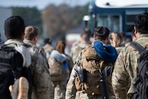 Joint Base Charleston Airmen walk toward the buses after returning from Joint Pacific Multinational Readiness Center rotation 26-01.