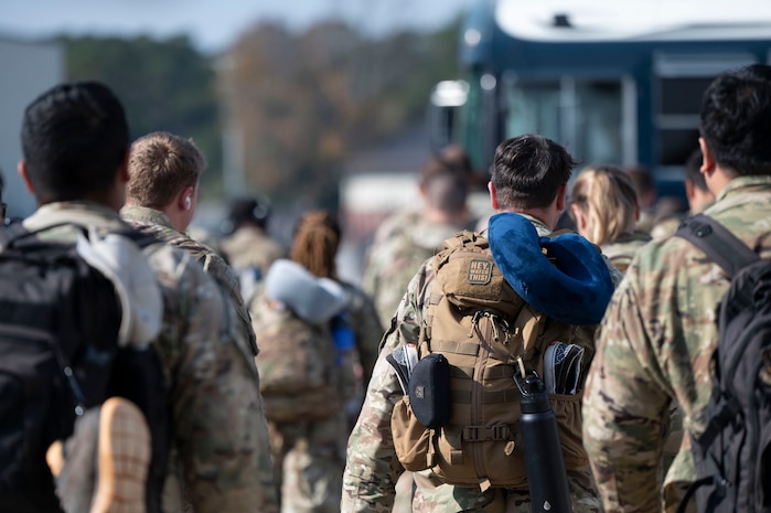 Joint Base Charleston Airmen walk toward the buses after returning from Joint Pacific Multinational Readiness Center rotation 26-01.