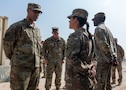 U.S. Air Force Gen. Adrian Spain, commander of Air Combat Command, speaks with U.S. Army SPC Marisa Gagnon, Charlie Battery, 2nd Battalion, 43rd Air Defense Artillery Regiment, 11th Air Defense Artillery Brigade, tactical control assistant, within the U.S. Central Command area of responsibility, Nov. 18, 2025. Spain toured the Patriot missile site where Gagnon worked and emphasized the importance of air and ground integration for regional defense. (U.S. Air Force photo by Senior Airman Paige Weldon)