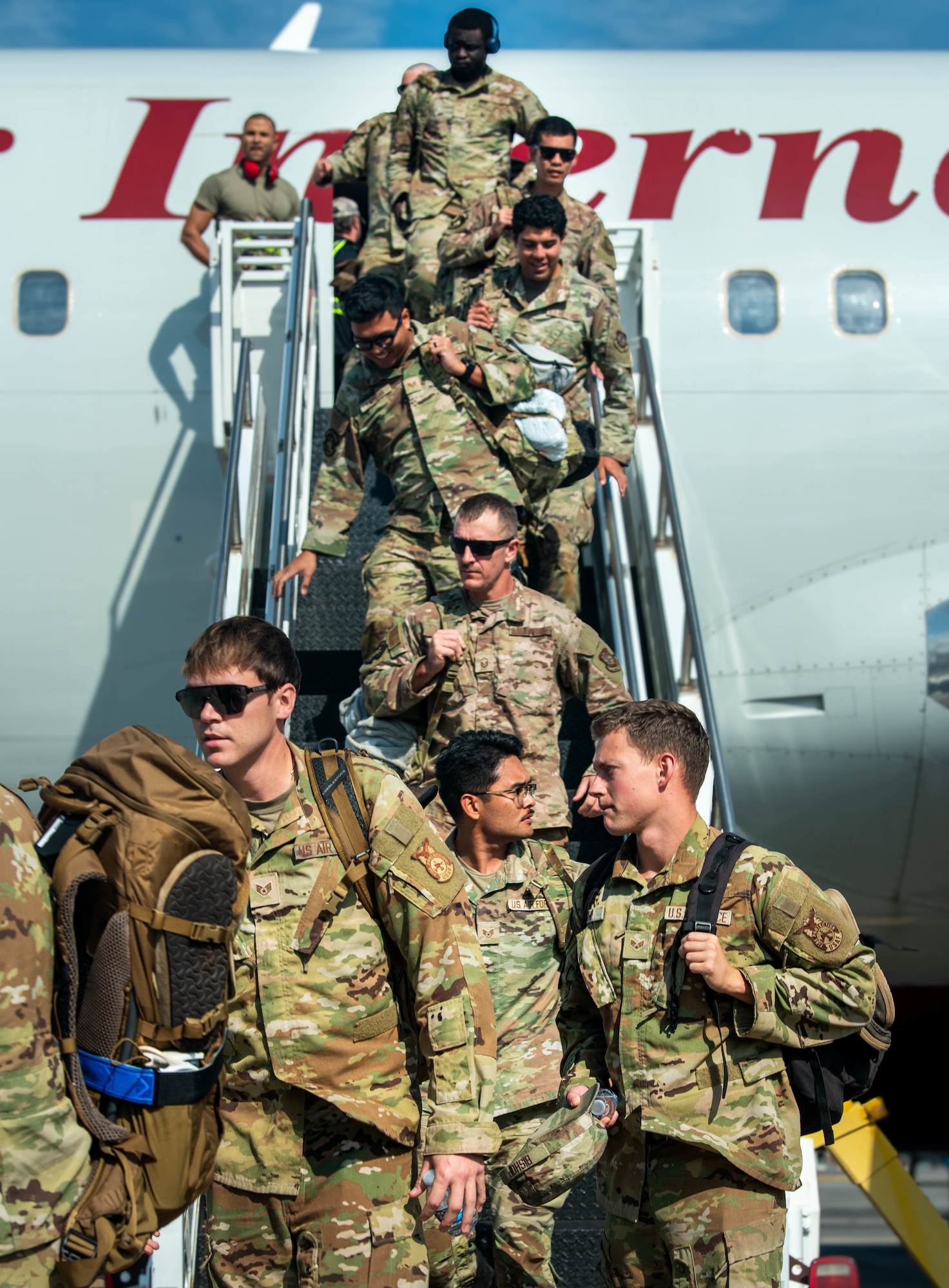 Joint Base Charleston Airmen deboard the plane upon returning from the Joint Pacific Multinational Readiness Center rotation 26-01 exercise.