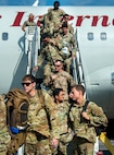 Joint Base Charleston Airmen deboard the plane upon returning from the Joint Pacific Multinational Readiness Center rotation 26-01 exercise.