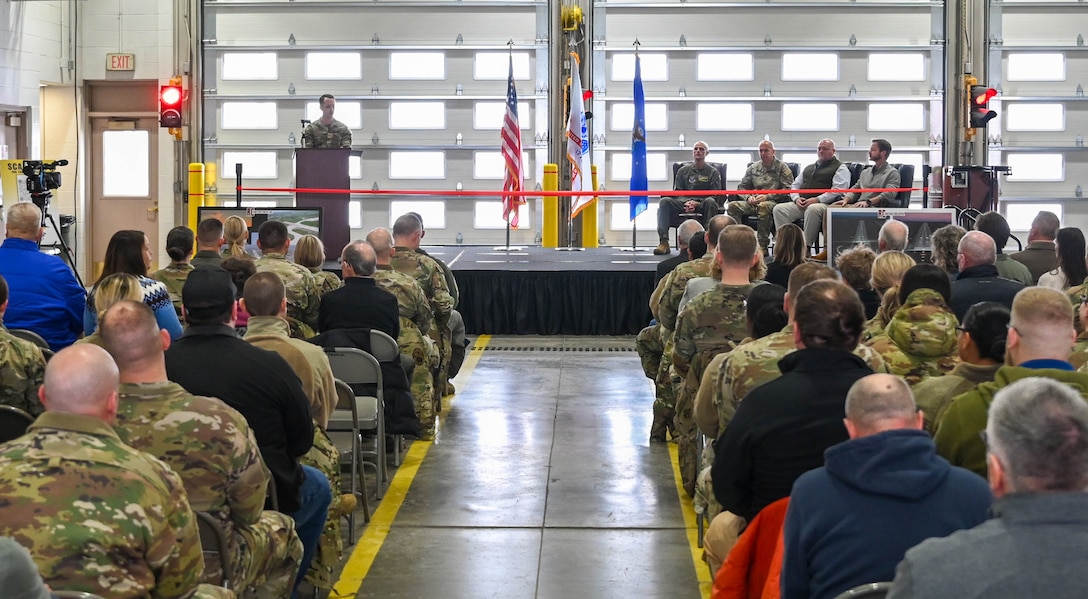 U.S. Air Force Staff Sgt. Hayden Newmiller, 28th Communication Squadron network and server administration journeyman, narrates a ribbon cutting ceremony at Ellsworth Air Force Base, S.D., Dec. 3, 2025.