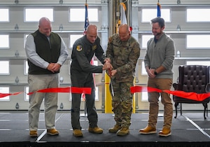 U.S. Air Force Col. Erick Lord, (left), 28th Bomb Wing commander, and U.S. Army Col. Robert Newbauer cut a ribbon during a ribbon cutting ceremony at Ellsworth Air Force Base, S.D., Dec. 3, 2025.