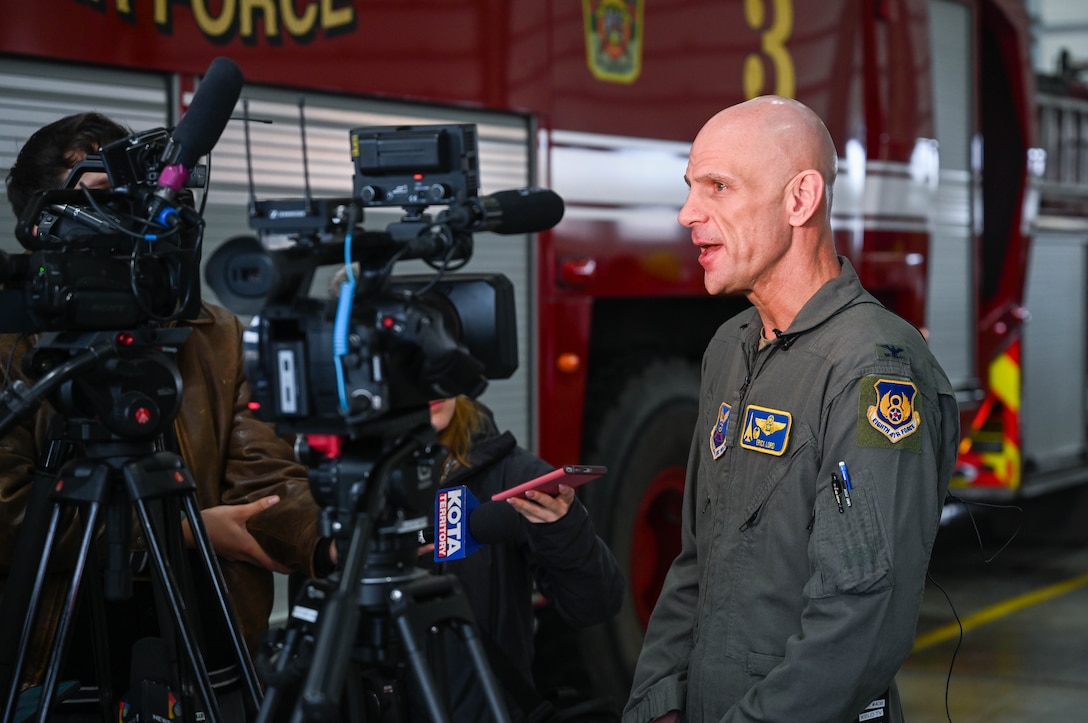 U.S. Air Force Col. Erick Lord, 28th Bomb Wing commander, speaks with local media members after a ribbon cutting ceremony at Ellsworth Air Force Base, S.D., Dec. 3, 2025.