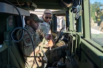 U.S. Army Sgt. Kaleel Ivy, wheeled vehicle mechanic with the 1st Battalion, 204th Air Defense Artillery Regiment, Mississippi National Guard, instructs U.S. Air Force Airman 1st Class Joseph Frazier, 11th Civil Engineer Squadron structural journeyman, on basic operations of a Humvee at Fort Belvoir, Va., Oct. 16, 2025.