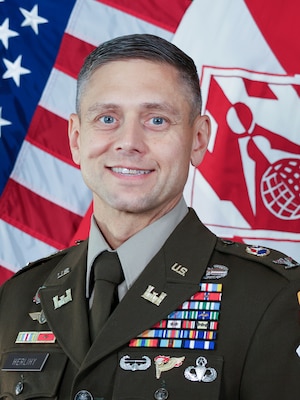 Man in front of flags