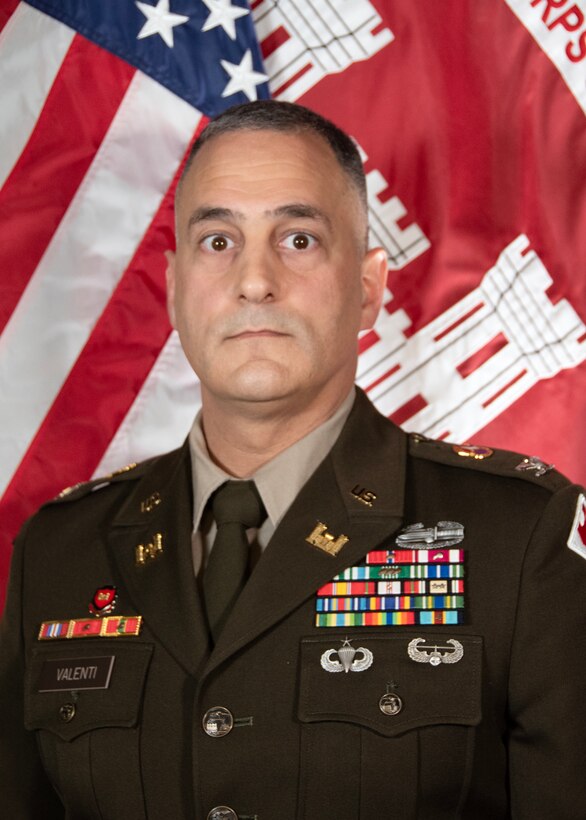 Man standing in front of flags