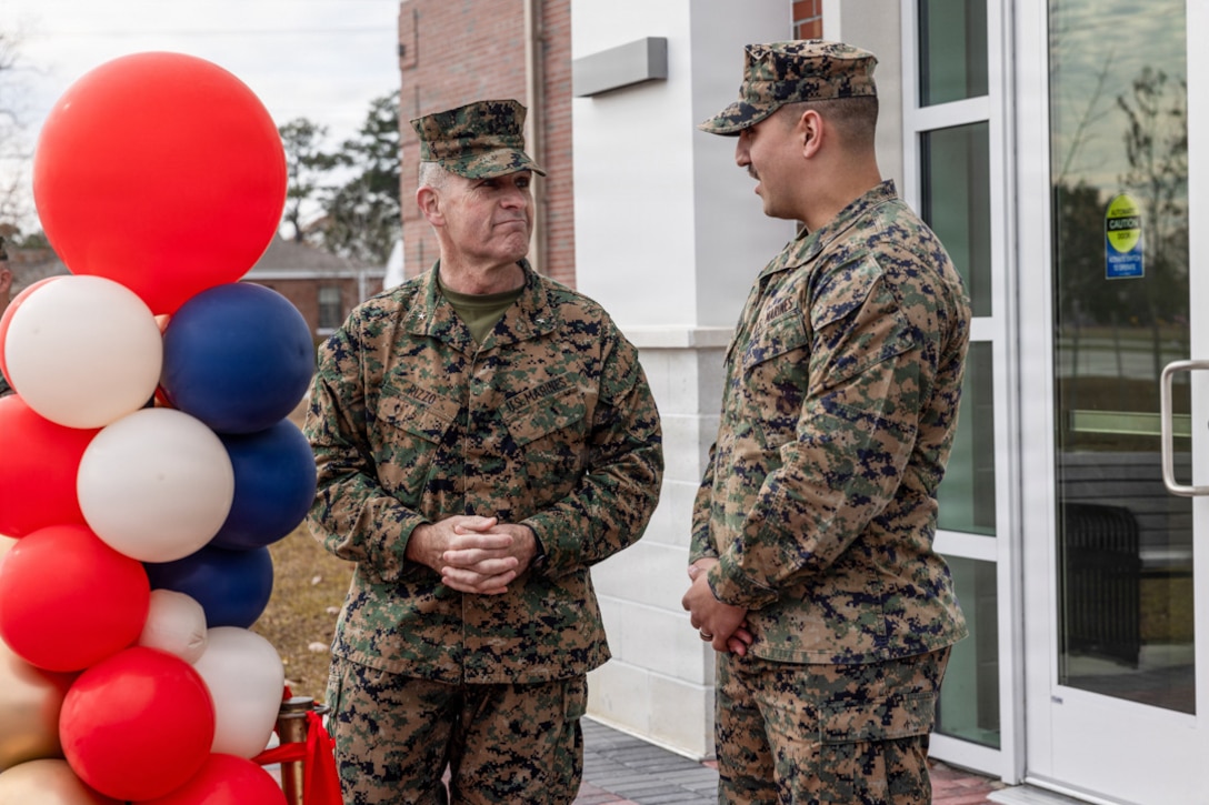 U.S. Marine Corps Brig. Gen. Ralph J. Rizzo, Jr., commanding general, Marine Corps Installations East-Marine Corps Base (MCB) Camp Lejeune, left, speaks with Gunnery Sgt, Jorden Macintre, chief for Regional Office of Special Trial Counsel East, during a ribbon cutting ceremony at the Regional Law Center East Legal Services Complex, MCB Camp Lejeune, North Carolina, Dec. 4, 2025. The new regional law center marks a major modernization effort that improves operational efficiency by housing legal support functions in one building and restores legal capabilities displaced by Hurricane Florence across MCB Camp Lejeune. (U.S. Marine Corps photo by Cpl. Daniela Chicas Torres)