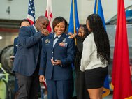 Family members of U.S. Air Force Brig. Gen. Natasha S. Taylor, director of the Joint Staff, Joint Force Headquarters, District of Columbia National Guard, pin the one-star rank on her at a ceremony formally promoting her on Joint Base Andrews, Maryland, Dec. 3, 2025. In this role, she is responsible for overseeing and managing the development, execution, and evaluation of joint staff programs and policies pertaining to the command, control, and operation of joint functions within the District of Columbia Army and District of Columbia Air National Guard. She manages readiness of joint defense programs to include the Civil Support Team, Homeland Response Force, State Partnership Program, Counter Drug Task Force, and Defense Support to Civil Authorities. (U.S. Air National Guard photo by Tech. Sgt. Andrew Enriquez)