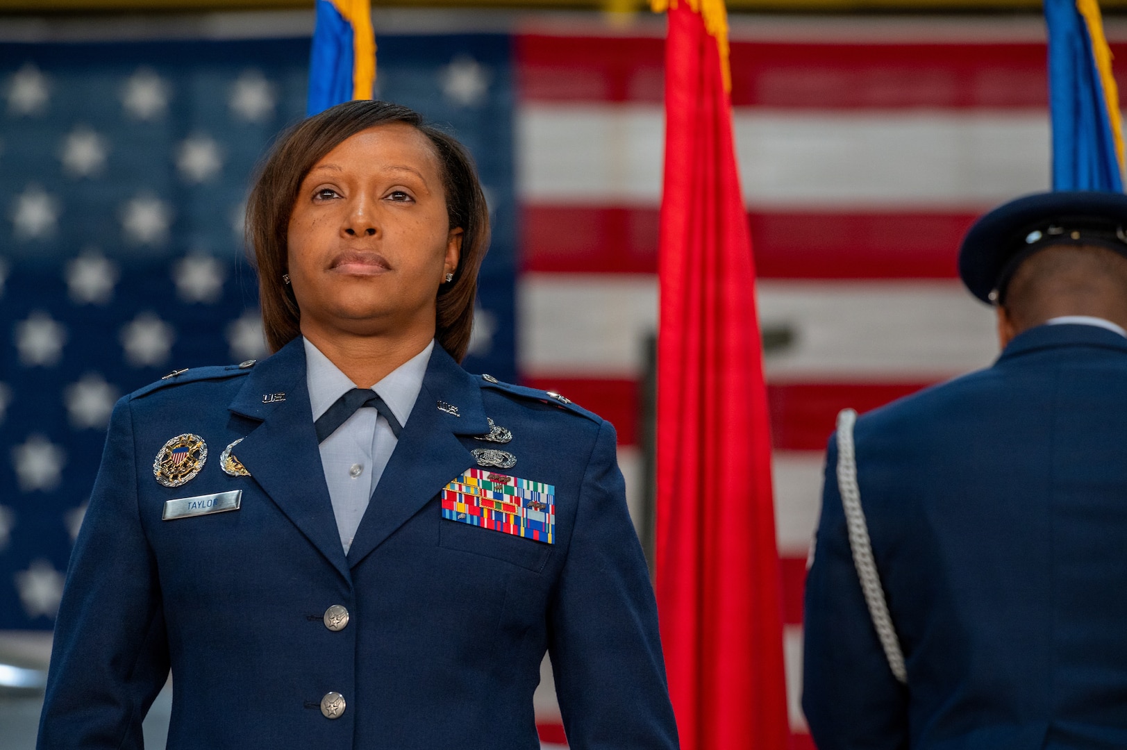 Brig. Gen. Natasha S. Taylor, director of the Joint Staff, Joint Force Headquarters, District of Columbia National Guard, stands at attention as her personal colors are posted during a ceremony formally promoting her to the rank on Joint Base Andrews, Maryland, Dec. 3, 2025. In this role, she is responsible for overseeing and managing the development, execution, and evaluation of joint staff programs and policies pertaining to the command, control, and operation of joint functions within the District of Columbia Army and District of Columbia Air National Guard. She manages readiness of joint defense programs to include the Civil Support Team, Homeland Response Force, State Partnership Program, Counter Drug Task Force, and Defense Support to Civil Authorities. (U.S. Air National Guard photo by Tech. Sgt. Andrew Enriquez)