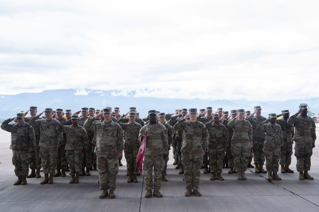 People in military uniforms stand in formation