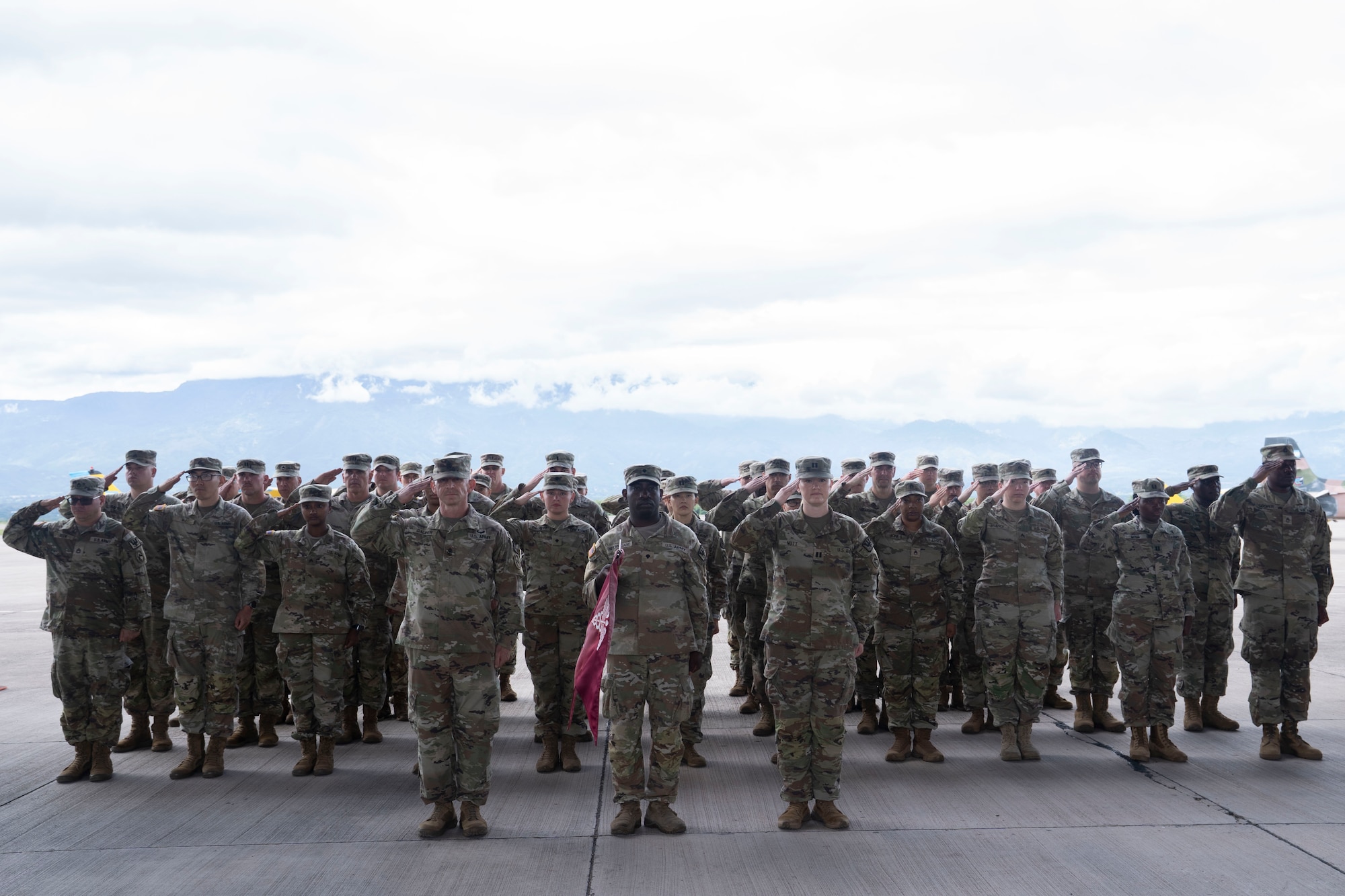 People in military uniforms stand in formation