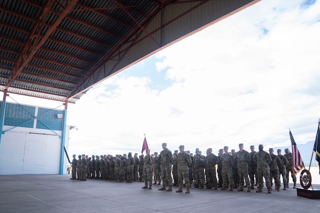 A group of people in military uniforms stand in formation