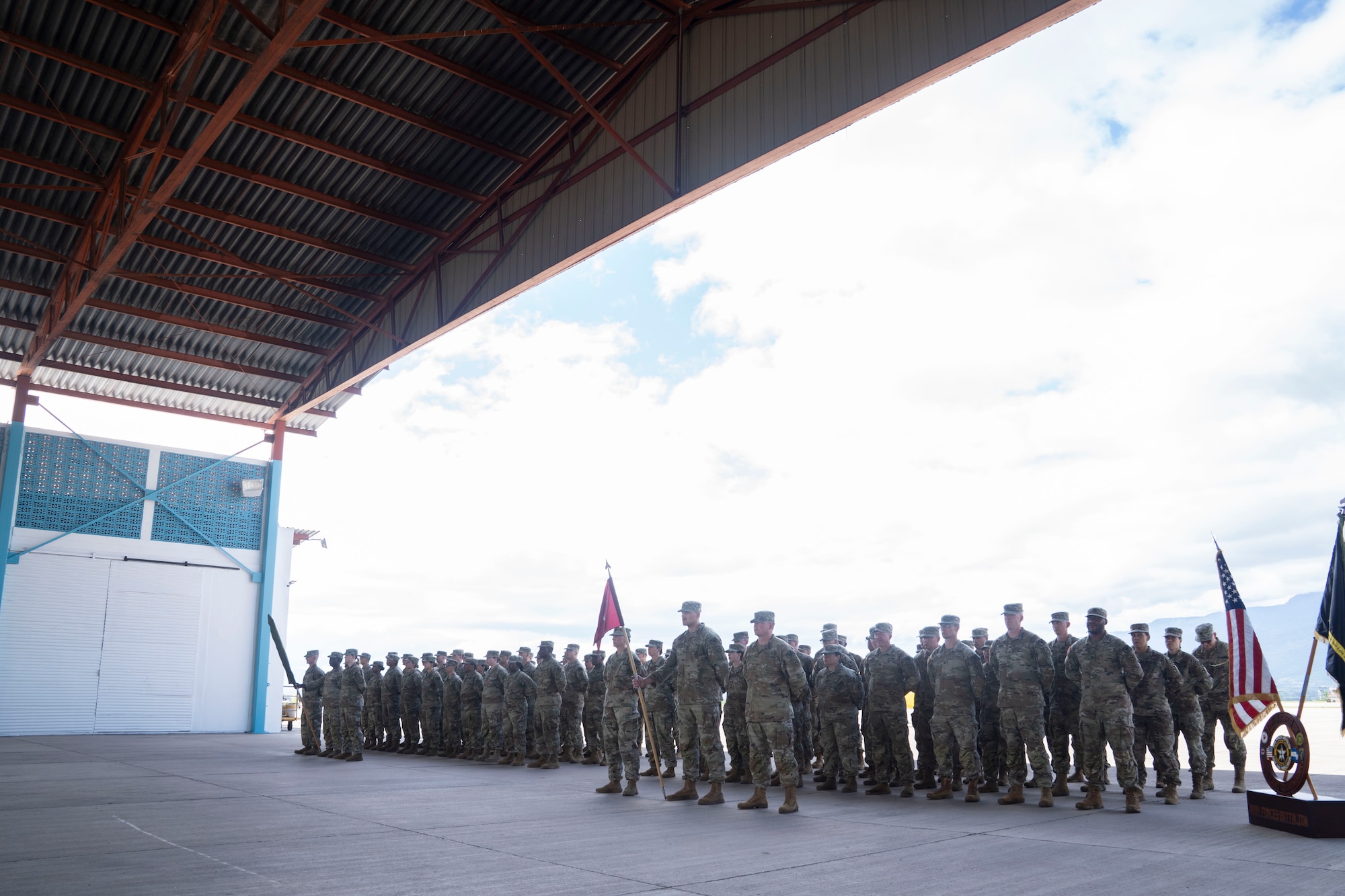 A group of people in military uniforms stand in formation