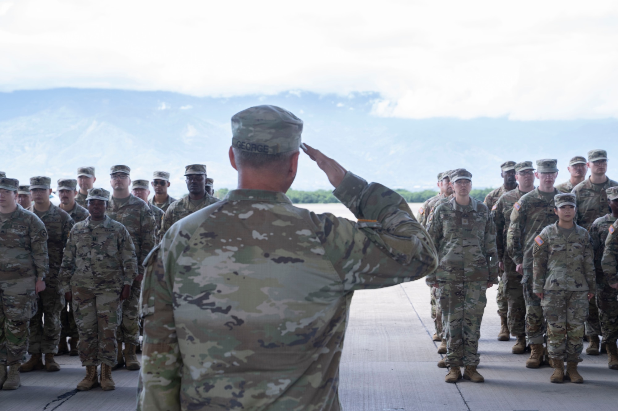 People in military uniforms stand in formation