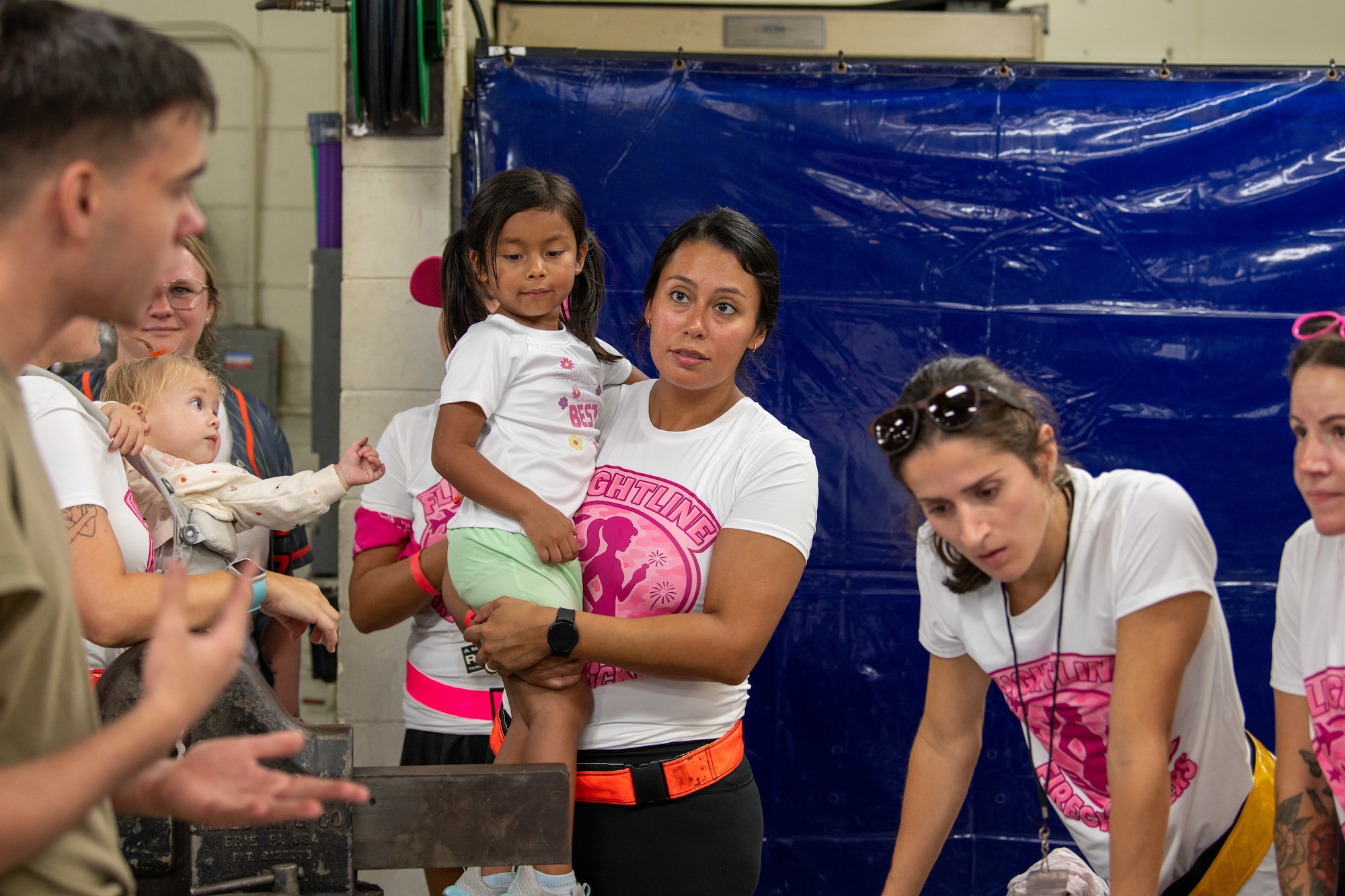 A group of participants listen to instructions for a challenge.