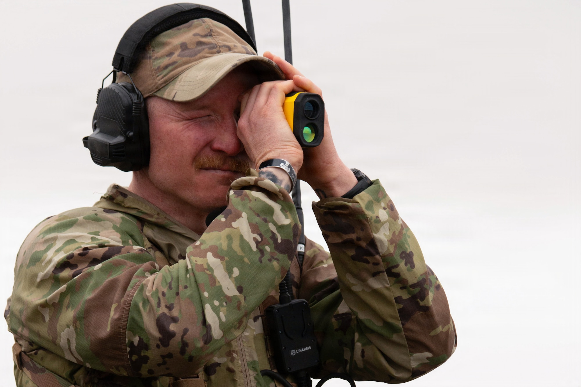 Tech. Sgt. Dylan Drenner, a landing zone safety officer (LZSO) assigned to the 3rd Operations Support Squadron, uses a rangefinder to prepare for a landing during an austere environment landing exercise on Joint Base Elmendorf-Richardson, Alaska, Sept. 26, 2025. LZSOs manage landing zones, airspace management and coordination for medical evacuation personnel. Management of airspace and landing zones reinforces safety for aircraft and personnel on the flightline, preventing any factors from conflicting with another. (U.S. Air Force photo by Airman Vischi)