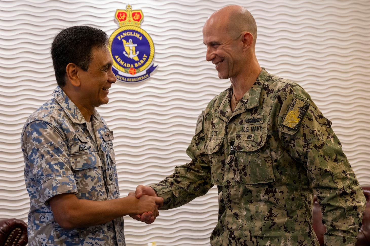 U.S. Navy Capt. Matth Cox, deputy commodore, Destroyer Squadron (DESRON) 7,shakes hands with Royal Malaysian Navy (RMN) Western Fleet Commander, Vice Adm. Dato’ Baharudin bin Wan Md Nor, during an office call during Cooperation Afloat Readiness and Training (CARAT) Malaysia 2025 at Lumut Naval Base, in Lumut, Malaysia, Dec. 4, 2025.This year marks the 31st iteration of CARAT, a multinational exercise series designed to enhance U.S. and partner navies' abilities to operate together in response to traditional and nontraditional maritime security challenges in the Indo-Pacific region. (U.S. Navy photo by Mass Communication Specialist 2nd Class Anthony Robledo)