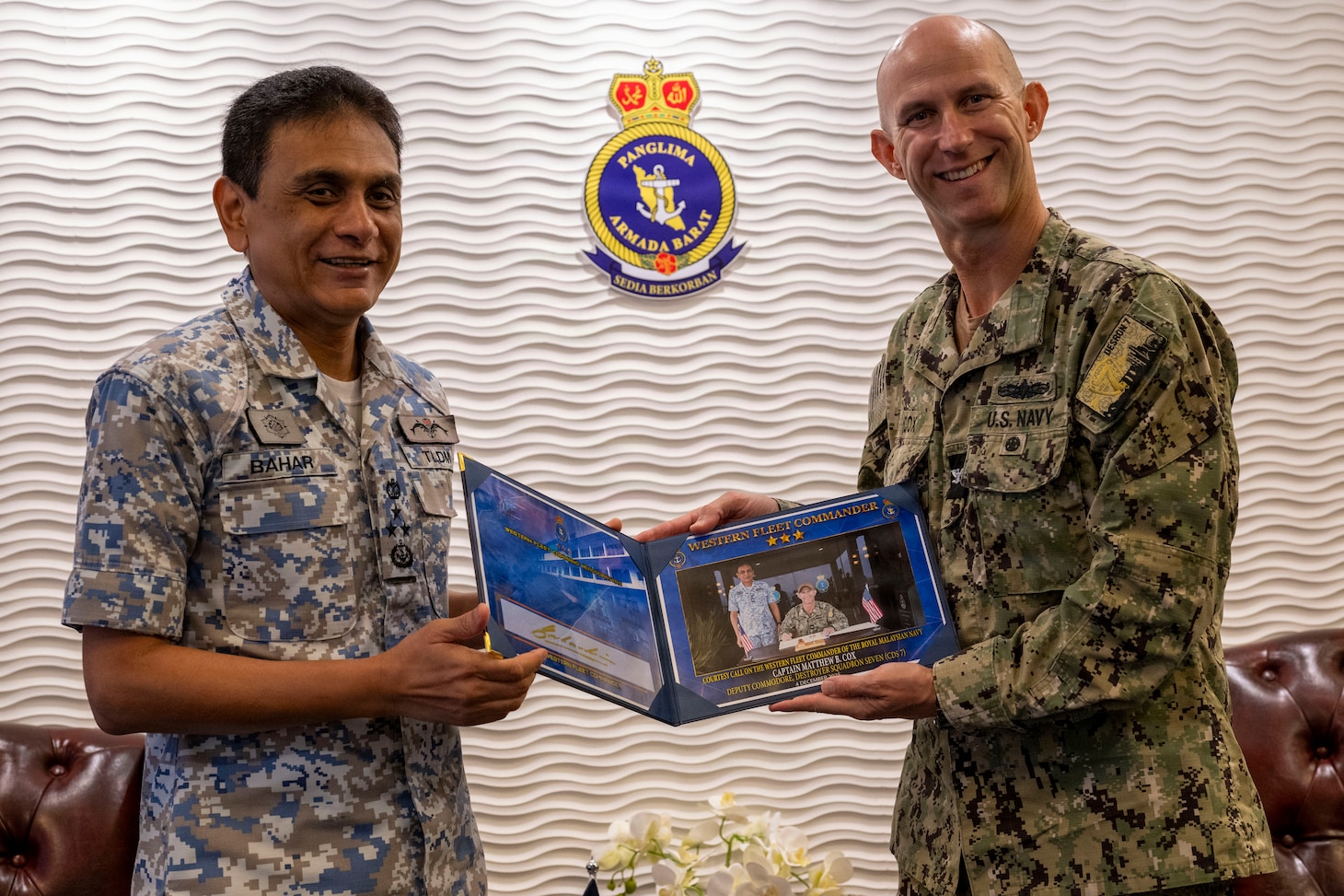 U.S. Navy Capt. Matt Cox, deputy commodore, Destroyer Squadron (DESRON) 7, poses for a photo with Royal Malaysian Navy (RMN) Western Fleet Commander, Vice Adm. Dato’ Baharudin bin Wan Md Nor, during an office call during Cooperation Afloat Readiness and Training (CARAT) Malaysia 2025 at Lumut Naval Base, in Lumut, Malaysia, Dec. 4, 2025.This year marks the 31st iteration of CARAT, a multinational exercise series designed to enhance U.S. and partner navies' abilities to operate together in response to traditional and nontraditional maritime security challenges in the Indo-Pacific region. (U.S. Navy photo by Mass Communication Specialist 2nd Class Anthony Robledo)