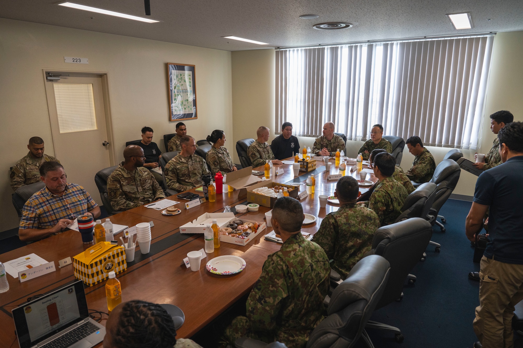 Members of the 18th Security Forces Squadron and Japan Ground Self-Defense Force discuss defense coordination during a tabletop exercise at Kadena Air Base, Japan, Oct. 25, 2025