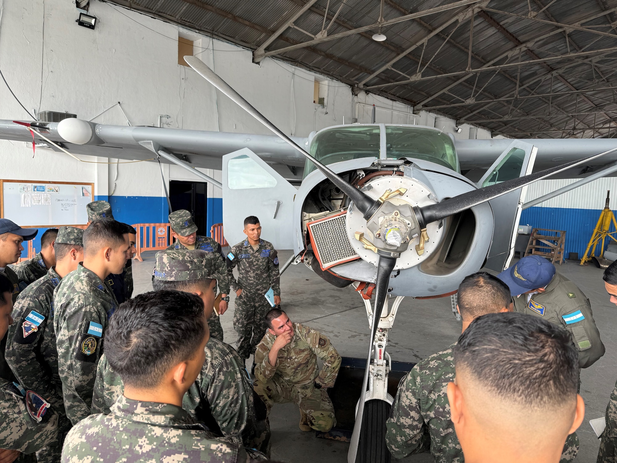 People stand around a plane.