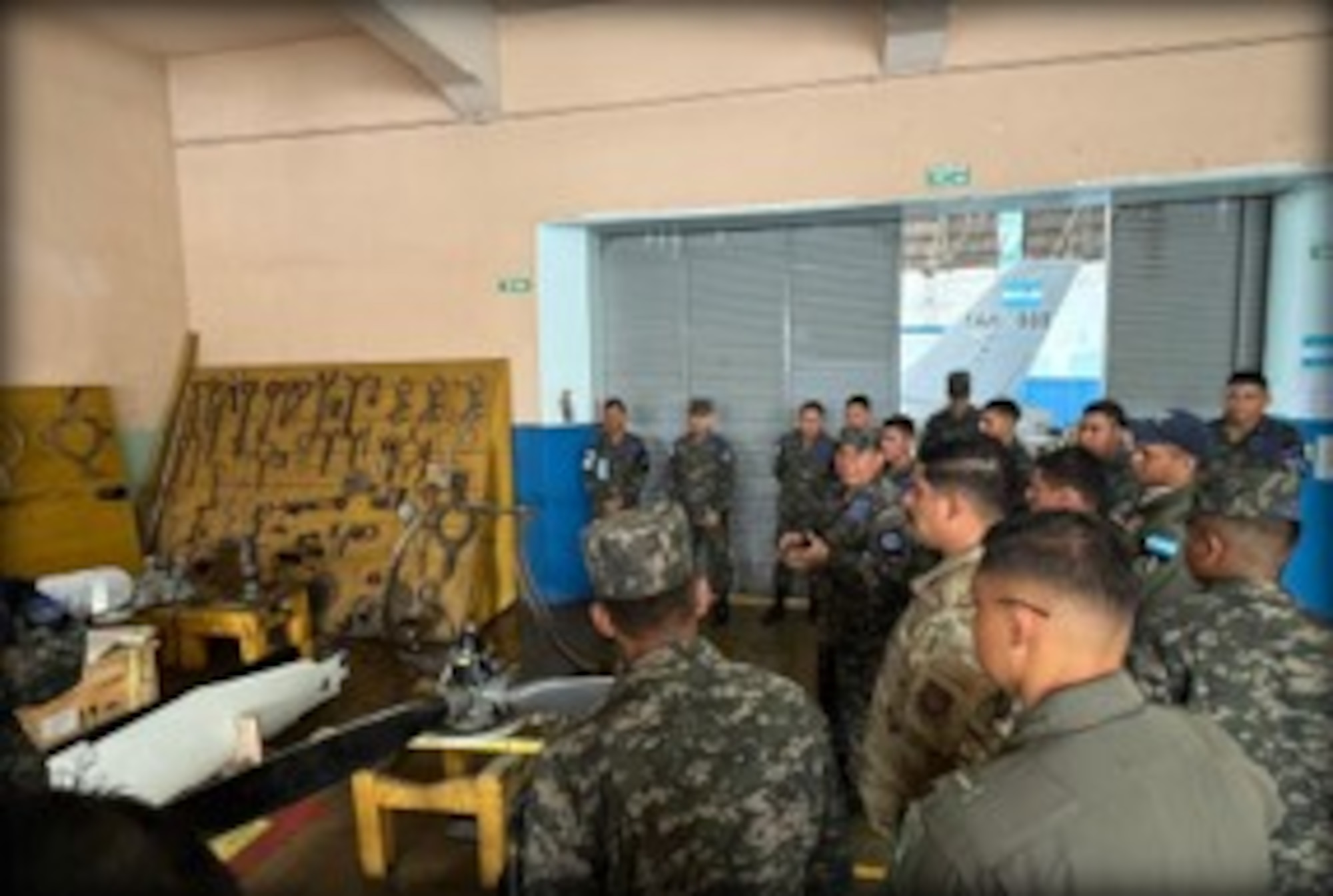 People stand in a room.