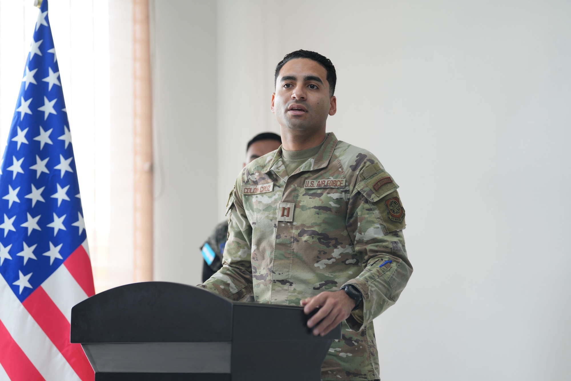 Man speaks from lectern.