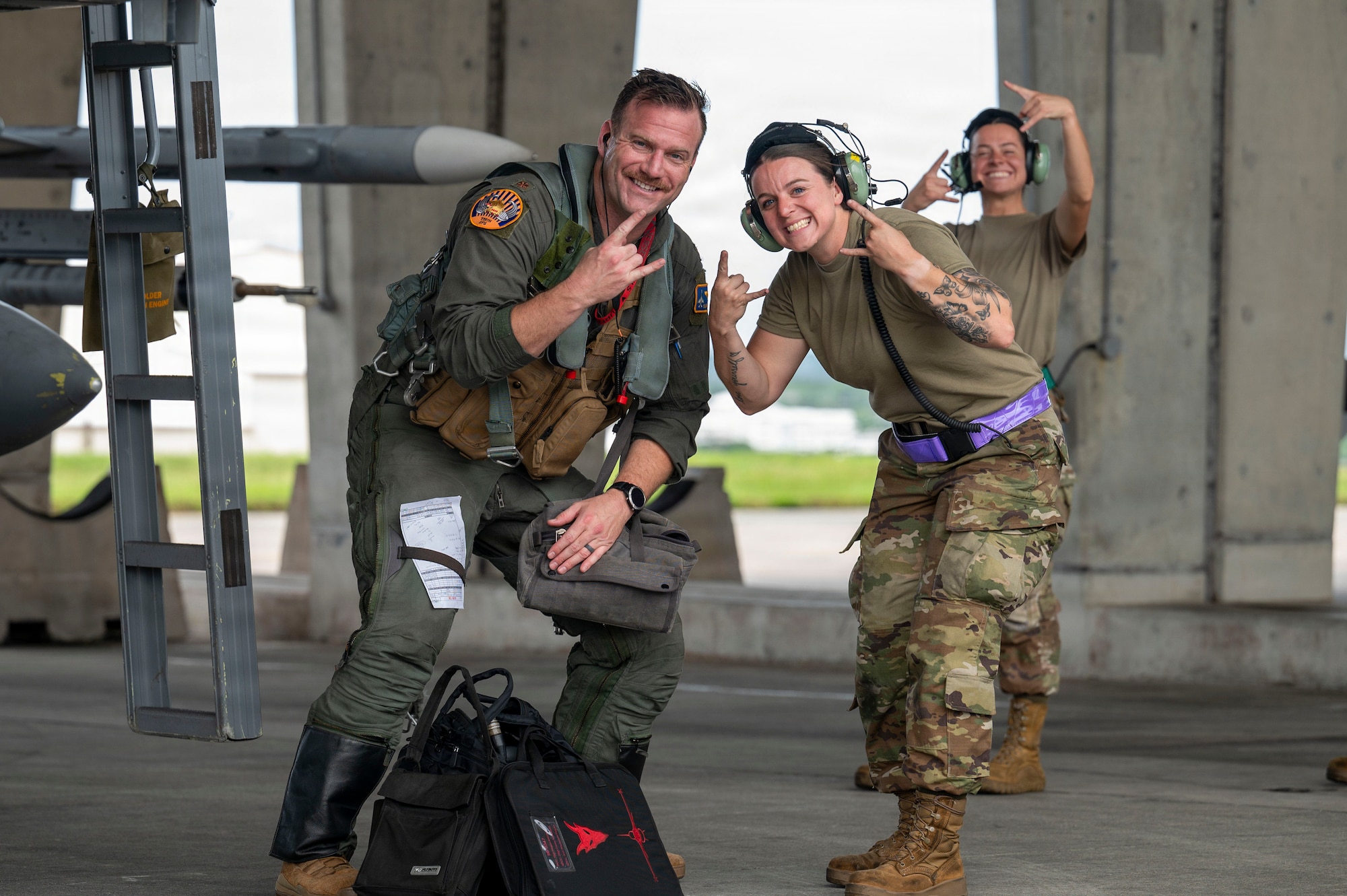 U.S. Air Force Maj. Patrick Schiffer, 119th Expeditionary Fighter Squadron F-16 Pilot, left, poses with Airmen from the 119th Expeditionary Fighter Generation Squadron at Kadena Air Base, Japan, Oct. 23, 2025.