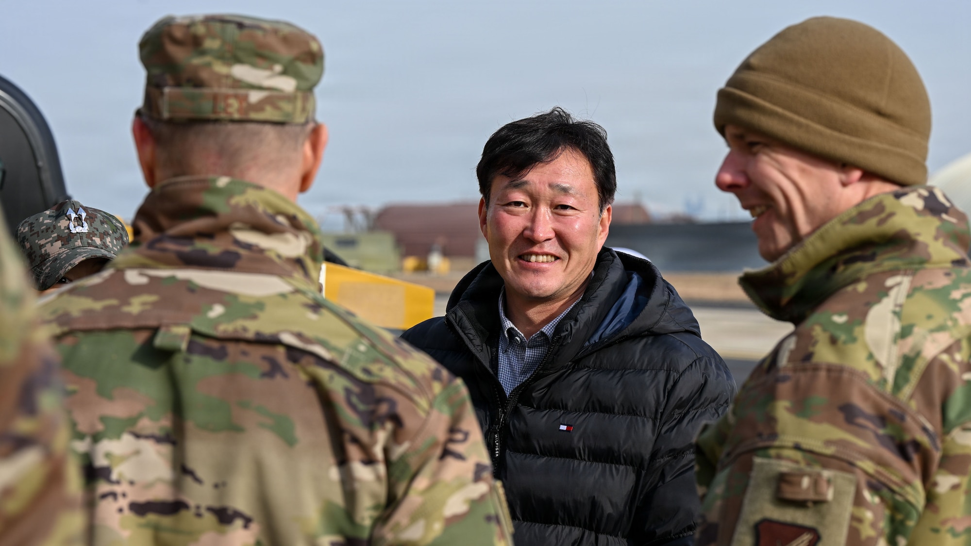 Mr. Kyungchak Kim, center, Republic of Korea Military National Defense-Defense Installations Agency deputy commander, speaks with U.S. Air Force Col. Ryan Ley, left, 51st Fighter Wing commander before a ribbon-cutting ceremony at Osan Air Base, ROK, December 3, 2025. MND-DIA funded $30M to construct an airfield damage recovery warehouse to support Team Osan’s mission to Fight Tonight. (U.S. Air Force photo by Staff Sgt. Dustin Braaten)
